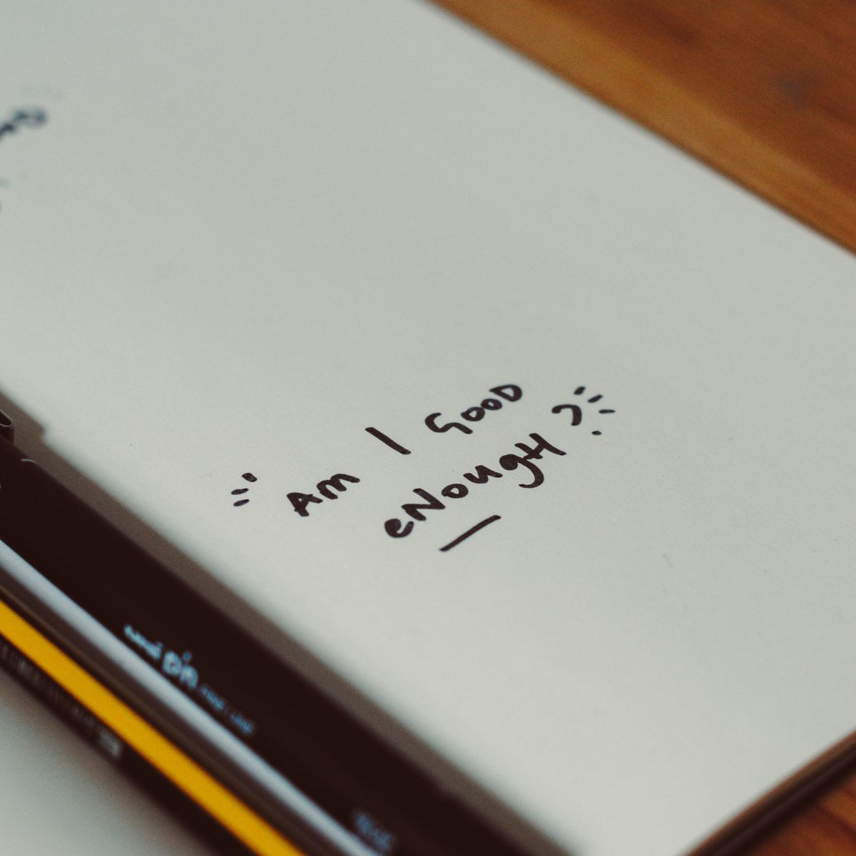 A notebook with the words Am I Good Enough relating to back-to-school anxiety