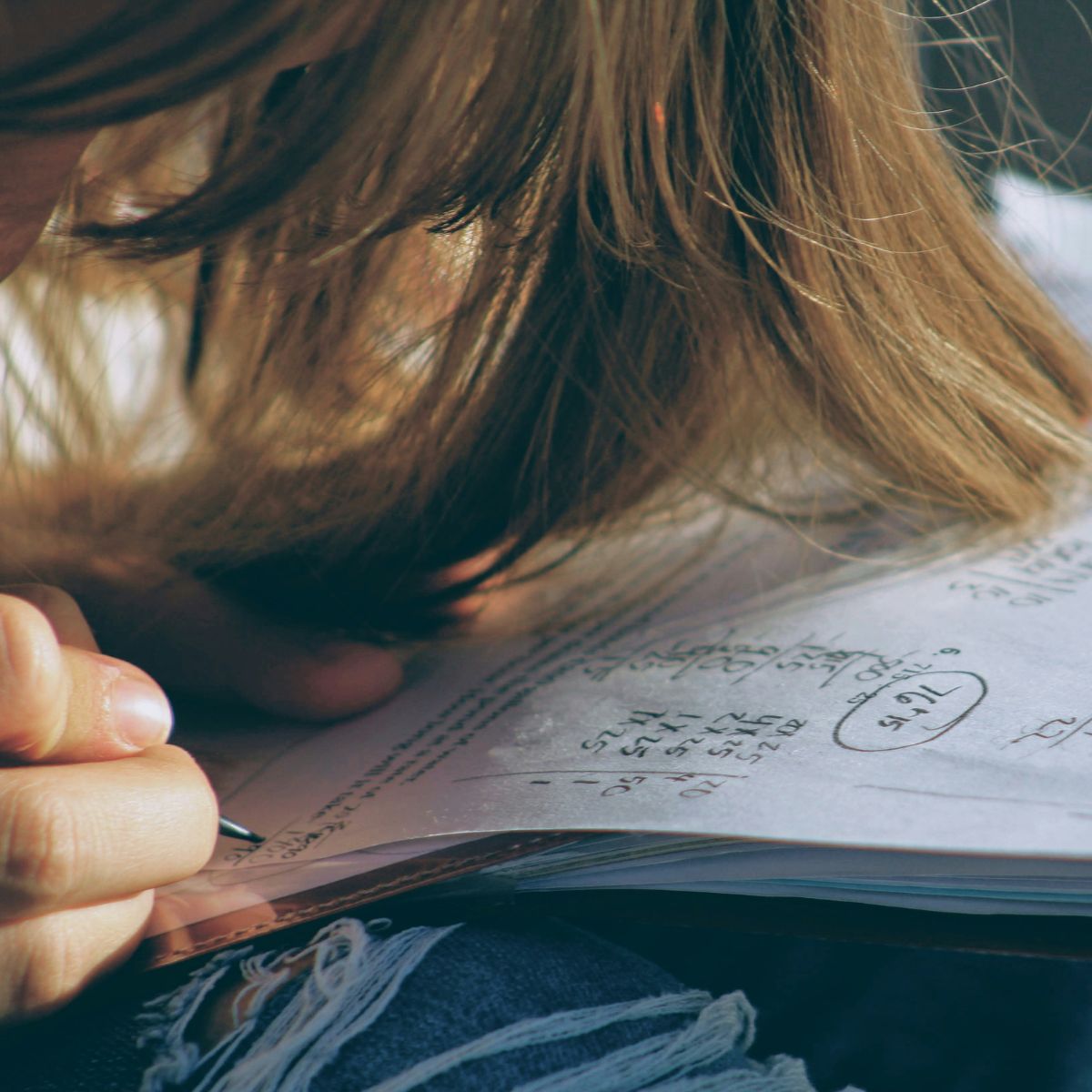A young girl working on her Maths homework for school