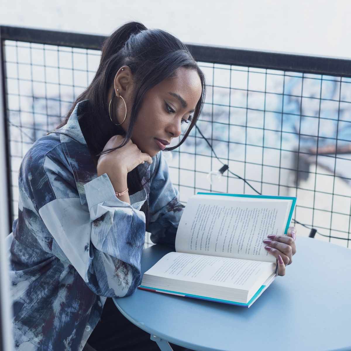 A parent reading a book about giving constructive feedback to teachers