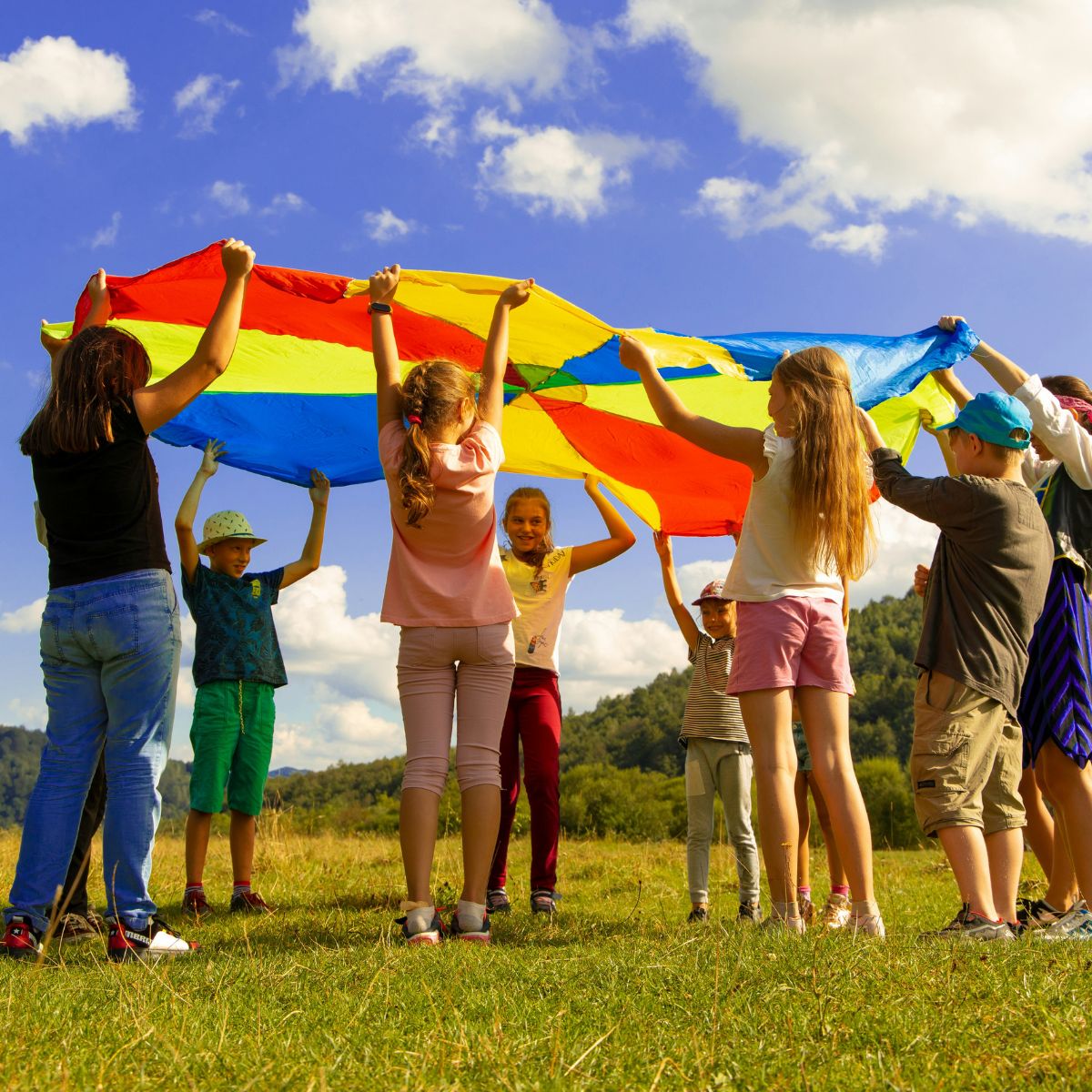 Children standing in a circle improving their spoken English skills together