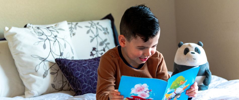 A child reading a book to develop analytical thinking skills