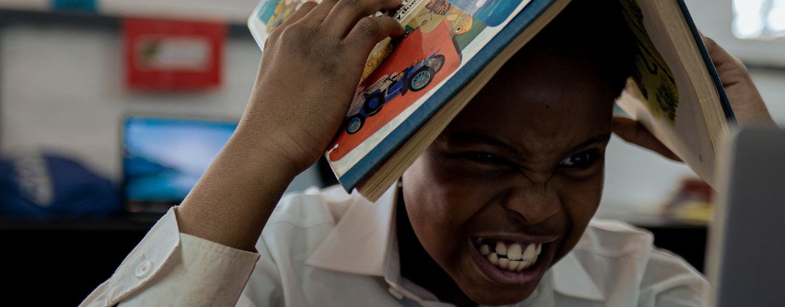 A tired student showing signs of study burnout at their desk